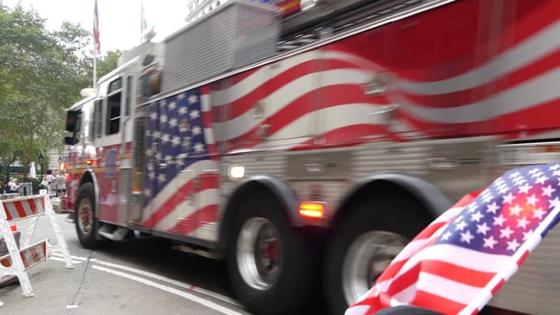 New York City, United States - 9 Sept 2023: NYFD car, USA fire department truck, american firefighters vehicle or fire fighter engine, Broadway, Manhattan Downtown financial district. Charging Bull.