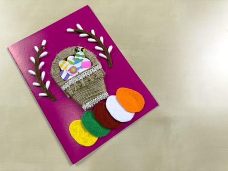 Delightful handmade Easter card features charming basket filled with colorful felt eggs and willow. Perfect for spreading joy and warm wishes during the Easter holiday season