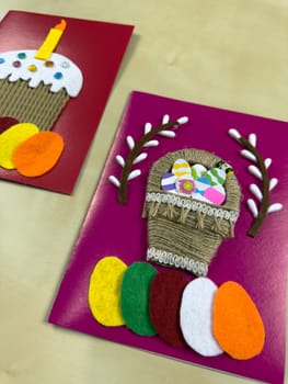 Delightful handmade Easter card features jute basket adorned with vibrant felt eggs and cheerful decorations. Ideal for sharing warm wishes and enhancing festive spirit during Easter celebrations