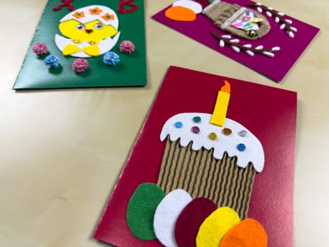 Delightful collection of handmade Easter cards includes cheerful chick, festive cake, and charming basket filled with colorful felt eggs. Perfect for sharing joy and warmth during Easter celebrations
