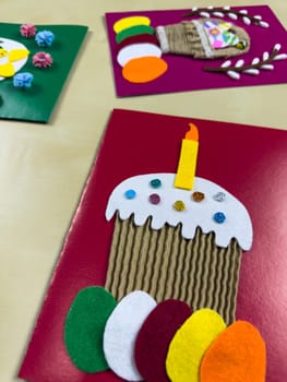 Festive assortment of handmade Easter cards showcases colorful cake with candle, charming basket filled with felt eggs. Ideal for celebrating Easter and sharing heartfelt greetings