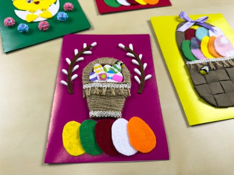 Delightful handmade Easter card showcases charming basket filled with vibrant felt eggs. Perfect for sharing joy and warm wishes during Easter celebrations with loved ones