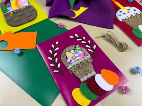 Vibrant display of handmade Easter cards adorned with colorful felt, yarn, and paper decorations. These intricately designed cards are perfect for celebrating Easter and spreading holiday cheer