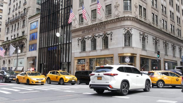 New York City, United States - 11 Sept 2023: Manhattan Midtown street, Fifth 5 avenue. American urban road car traffic, crossroad intersection. Yellow taxi cab in USA. People pedestrians go shopping.