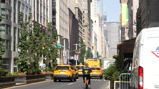 New York City, United States - 6 Sept 2023: Manhattan Midtown street, Park avenue near Madison Square Park. Urban road car traffic in USA. People. Yellow taxi cab. MetLife building near Grand Central.