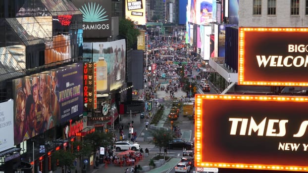New York City, United States - 14 Sept 2023: Times Square, Manhattan Midtown Broadway street, USA. American NYC urban road traffic, people from above. Commercial illuminated billboard screens glowing.