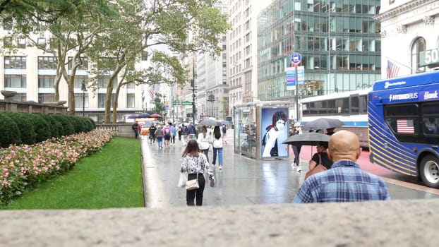 New York City, United States - 13 Sept 2023: Manhattan Midtown, Fifth 5 avenue. 42 street intersection corner near Bryant Park and Library, USA. American urban traffic, people pedestrian on rainy day.