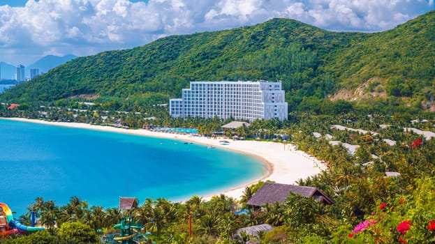 Luxury seaside hotel at sea with sandy beach in Nha Trang in Vietnam, top aerial view. A resort in Asia