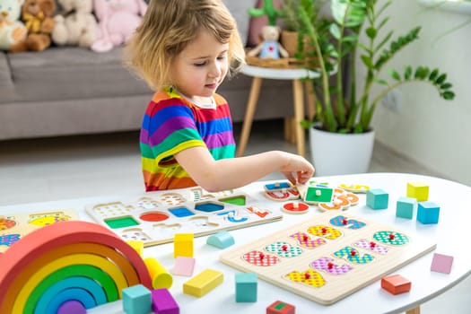 Child learns numbers and letters. Selective focus. Kid.