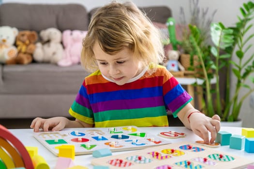Child learns numbers and letters. Selective focus. Kid.