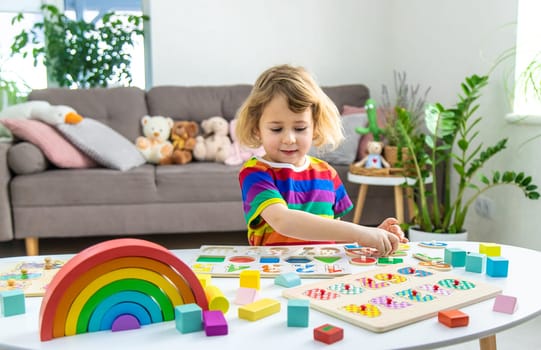 Child learns numbers and letters. Selective focus. Kid.