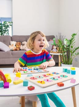 Child learns numbers and letters. Selective focus. Kid.
