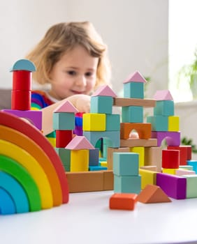 A child builds from blocks. Selective focus. kid.