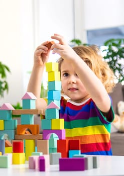 A child builds from blocks. Selective focus. kid.