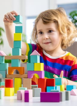 A child builds from blocks. Selective focus. kid.