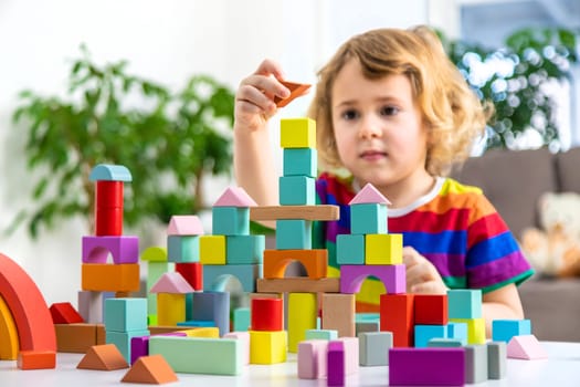A child builds from blocks. Selective focus. kid.