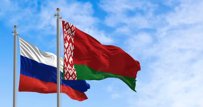 Photorealistic 3D render of Belarus and Russia flags waving side by side under a clear sky. Perfect for diplomacy, partnership and international relations themes
