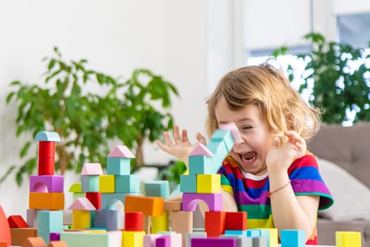A child builds from blocks. Selective focus. kid.
