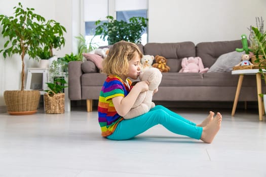 Child loves teddy bear at home. Selective focus. kid.