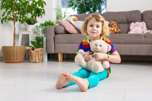 Child loves teddy bear at home. Selective focus. kid.