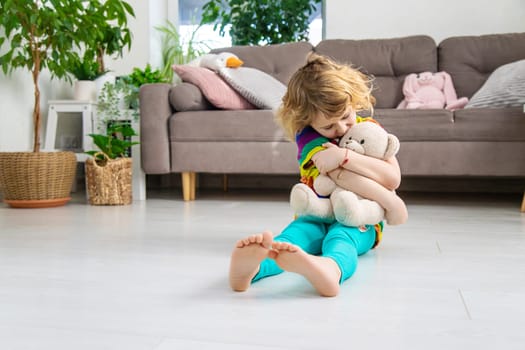 Child loves teddy bear at home. Selective focus. kid.