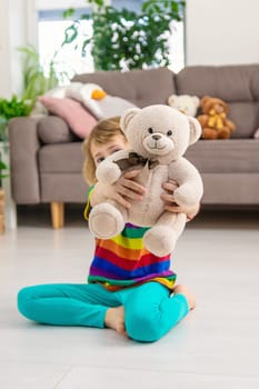 Child loves teddy bear at home. Selective focus. kid.