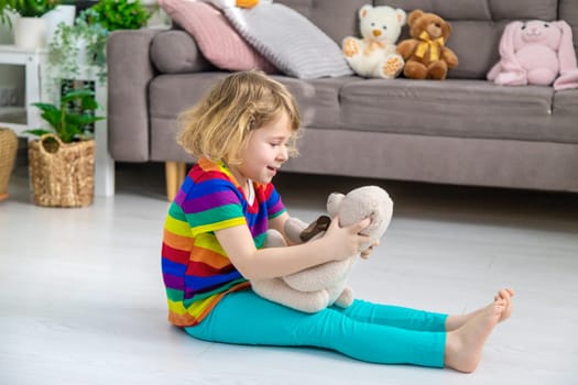 Child loves teddy bear at home. Selective focus. kid.