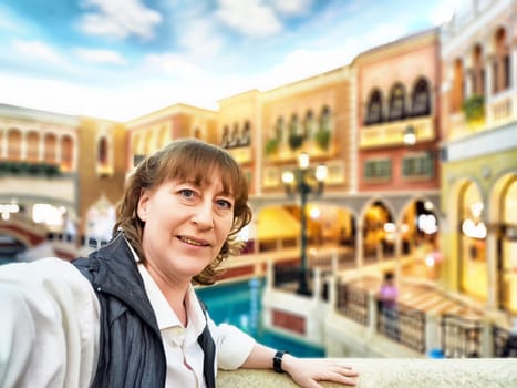 A visitor enjoys a lively moment by the canals of Macau, surrounded by unique architecture and entertainment.