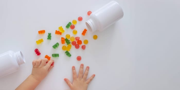 close-up of a little girl's hand taking jelly beans or vitamins