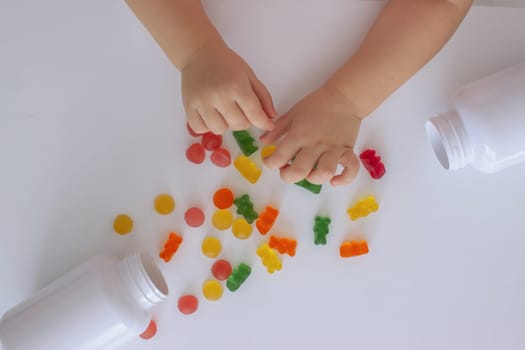 close-up of a little girl's hand taking jelly beans or vitamins