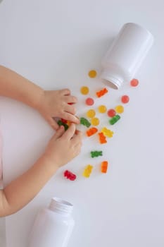 close-up of a little girl's hand taking jelly beans or vitamins
