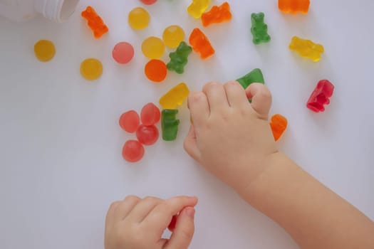 close-up of a little girl's hand taking jelly beans or vitamins