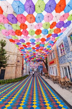 Hanging multicolored bright colorful umbrellas decoration Magic City Park in Tashkent. Tashkent, Uzbekistan - June 15, 2024