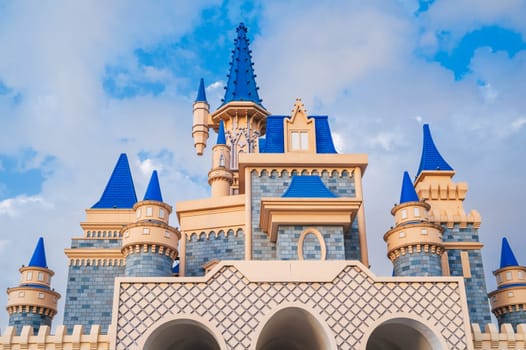 roof of a beautiful fantastic fairy tale castle in the Magic City amusement park in Tashkent in Uzbekistan on background of the blue sky