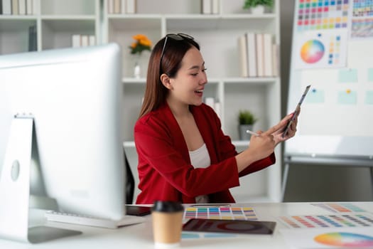 A creative professional shares insights using a tablet, harmonizing technology and innovation in a stylish study environment.