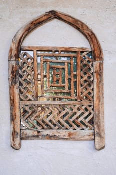old antique Uzbek wooden window with traditional carved pattern in Uzbekistan