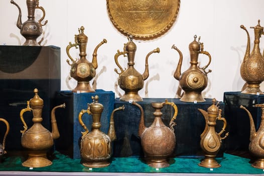 antique traditional Uzbek copper and brass jugs on exhibition at the Museum of Antiques in Tashkent in Uzbekistan