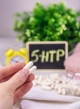 5-HTP sleep supplement capsules. Selective Focus. night.