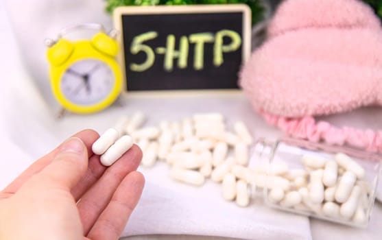 5-HTP sleep supplement capsules. Selective Focus. night.