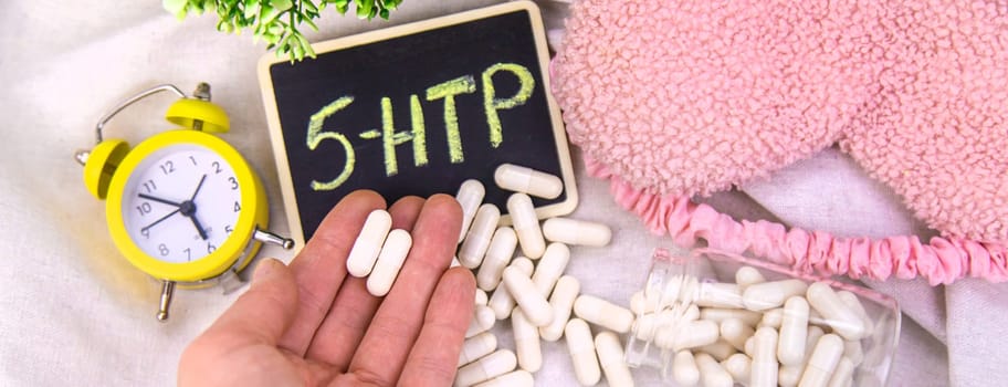 5-HTP sleep supplement capsules. Selective Focus. night.