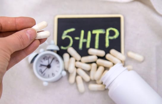 5-HTP sleep supplement capsules. Selective Focus. night.