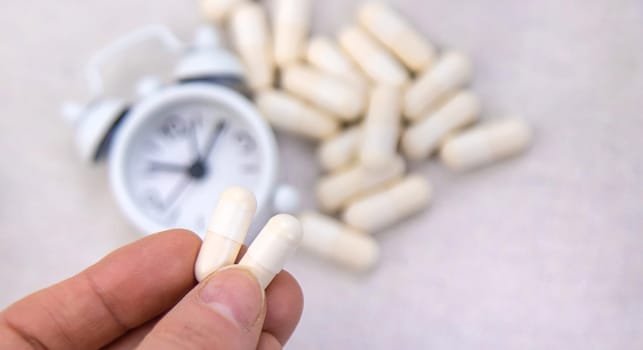 5-HTP sleep supplement capsules. Selective Focus. night.