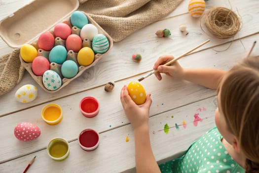 Kids joyfully engage in decorating colorful Easter eggs at home. With paints and brushes, they unleash their creativity, surrounded by a cozy spring atmosphere filled with pastel colors.