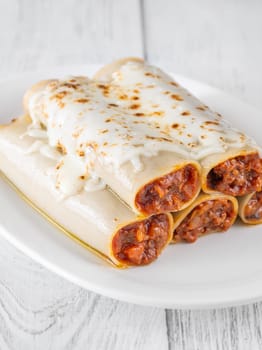 Delicate cannelloni pasta, generously filled with rich bolognese sauce, baked under a blanket of melted mozzarella