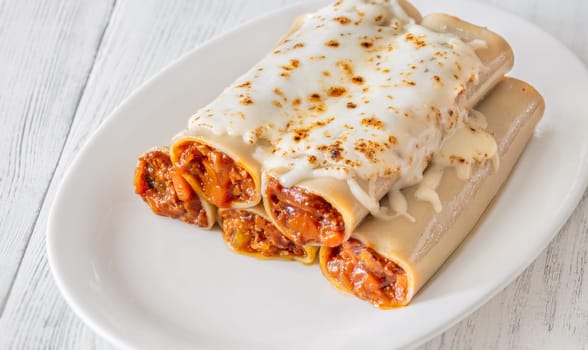 Delicate cannelloni pasta, generously filled with rich bolognese sauce, baked under a blanket of melted mozzarella