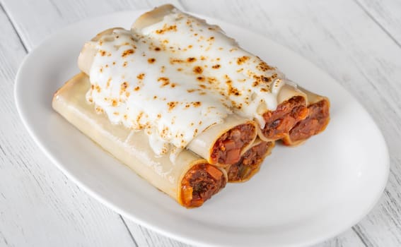 Delicate cannelloni pasta, generously filled with rich bolognese sauce, baked under a blanket of melted mozzarella