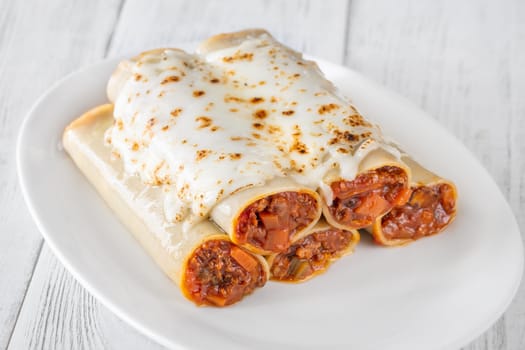 Delicate cannelloni pasta, generously filled with rich bolognese sauce, baked under a blanket of melted mozzarella