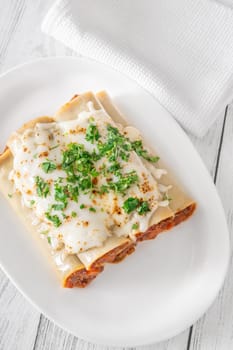 Delicate cannelloni pasta, generously filled with rich bolognese sauce, baked under a blanket of melted mozzarella