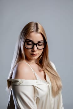 A stylish portrait showcasing a confident woman with beautifully long hair and trendy glasses, radiating elegance