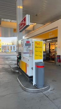 22.03.2025 Germany: Modern Shell Gas Station With Fuel Pumps and Convenience Store Exterior View. Urban Schell gas station featuring fuel pumps, brand signage, and an attached convenience store offering refreshments. Ideal depiction of modern fueling service facilities and retail amenities catering to customer needs.